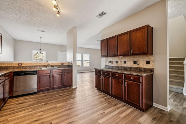 kitchen featuring light wood-style floors, visible vents, decorative backsplash, and stainless steel dishwasher