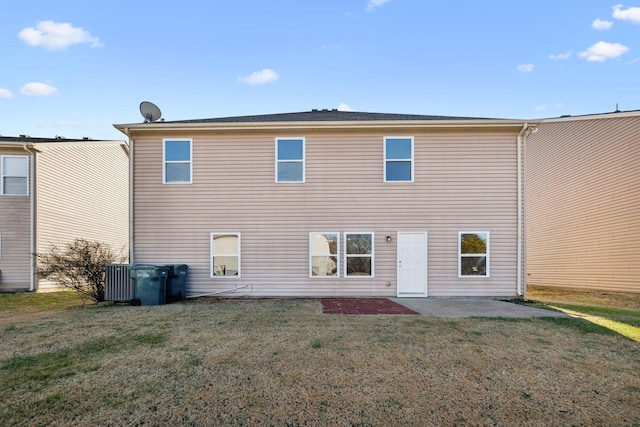 back of house featuring a yard and a patio area