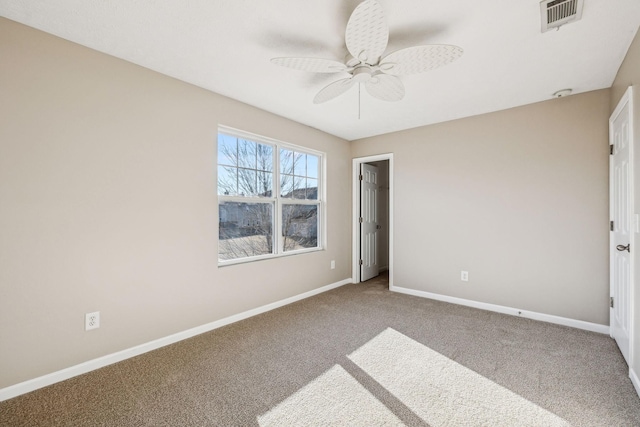 unfurnished bedroom featuring carpet, baseboards, visible vents, and ceiling fan