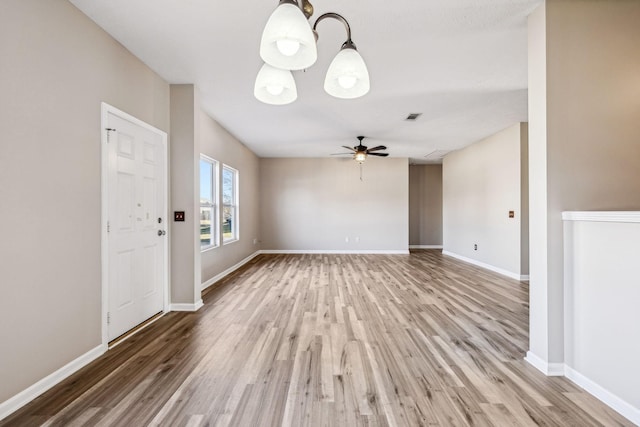 interior space with light wood-type flooring, baseboards, visible vents, and a ceiling fan