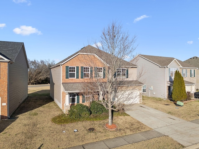 traditional-style house featuring a garage, driveway, and brick siding