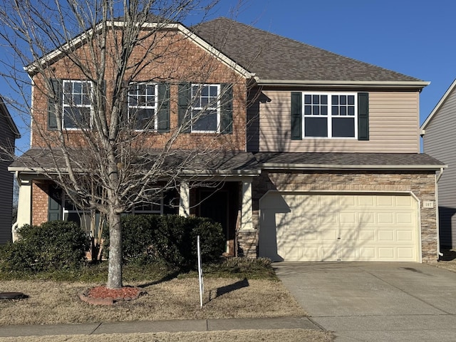 view of front of property with a garage, stone siding, a shingled roof, and concrete driveway