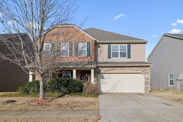 traditional-style house with a shingled roof, stone siding, driveway, and an attached garage