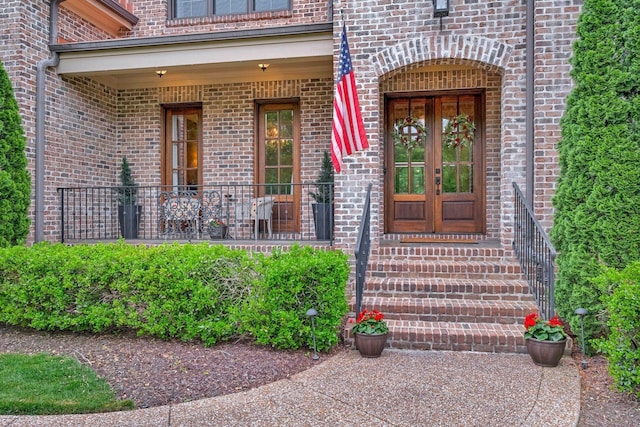 doorway to property with french doors and brick siding