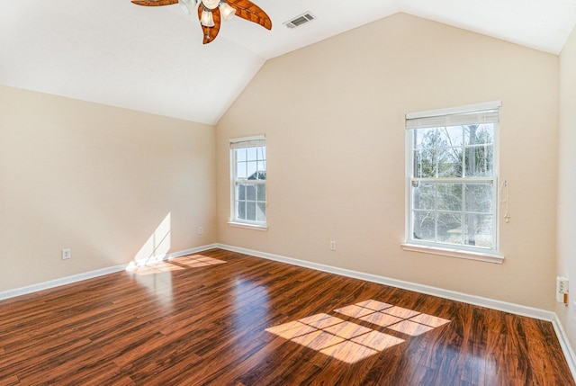 spare room with vaulted ceiling, plenty of natural light, and wood finished floors