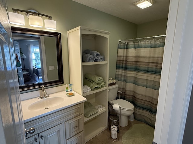 bathroom with toilet, a shower with curtain, vanity, and tile patterned floors