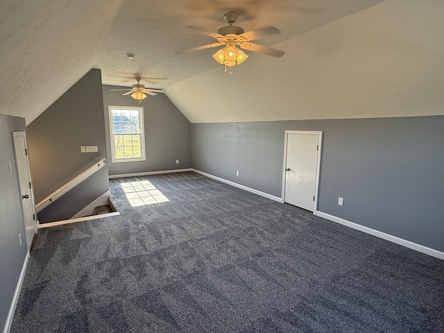 bonus room with a textured ceiling, carpet floors, vaulted ceiling, and baseboards