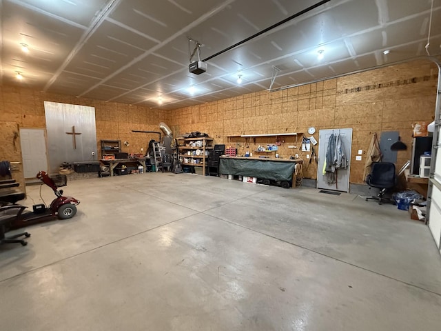 garage with a workshop area and a garage door opener