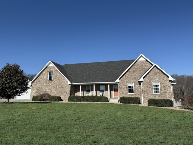 single story home with a garage, a front lawn, and brick siding