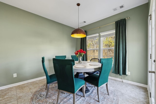 dining area featuring baseboards, visible vents, and tile patterned flooring