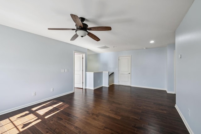 empty room with baseboards, visible vents, dark wood finished floors, and recessed lighting