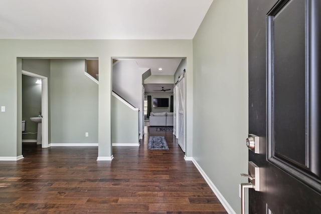 entrance foyer featuring baseboards and wood finished floors