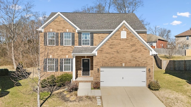 view of front of property featuring driveway, a shingled roof, fence, a front lawn, and brick siding