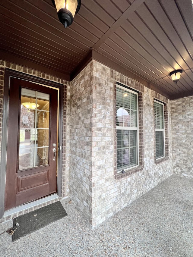 property entrance featuring brick siding