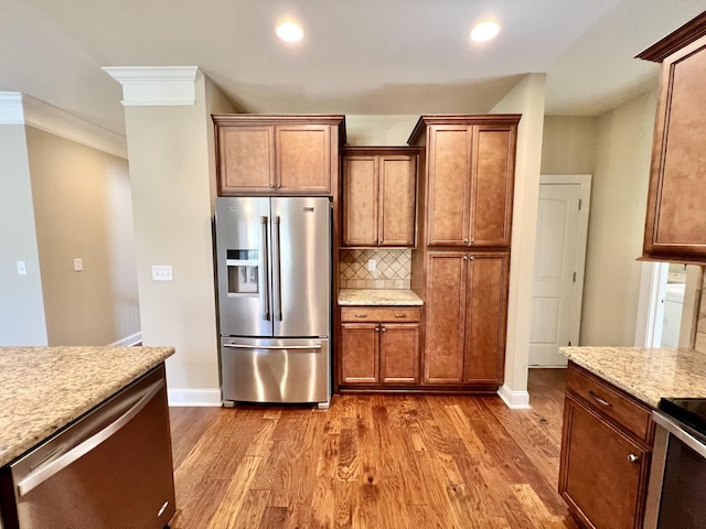 kitchen with stainless steel fridge, baseboards, decorative backsplash, dark wood-type flooring, and crown molding