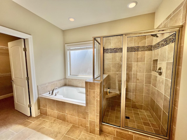 full bathroom featuring a shower stall, a walk in closet, a bath, and recessed lighting