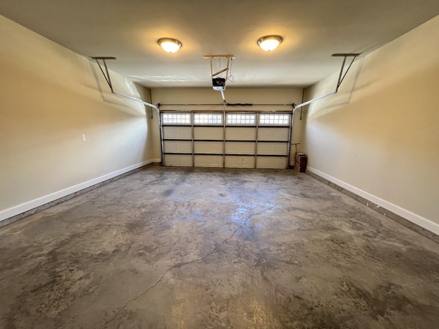 garage featuring a garage door opener and baseboards