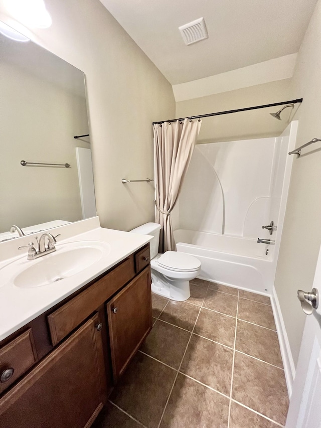 bathroom featuring toilet, visible vents, vanity, tile patterned floors, and shower / bath combo with shower curtain