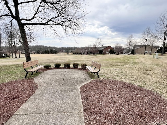 view of property's community with a yard and a patio area