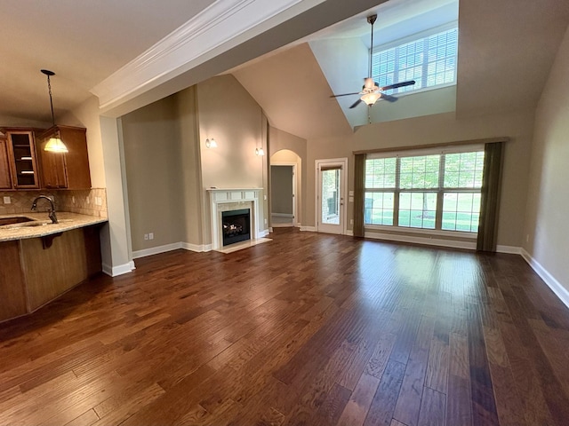 128 Village Cir, Lebanon, TN 37087 - unfurnished living room with a sink, ceiling fan, plenty of natural light, a premium fireplace, and high vaulted ceiling