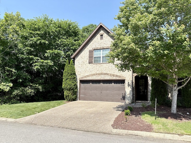 128 Village Cir, Lebanon, TN 37087 - view of front of home with concrete driveway, a garage, and brick siding