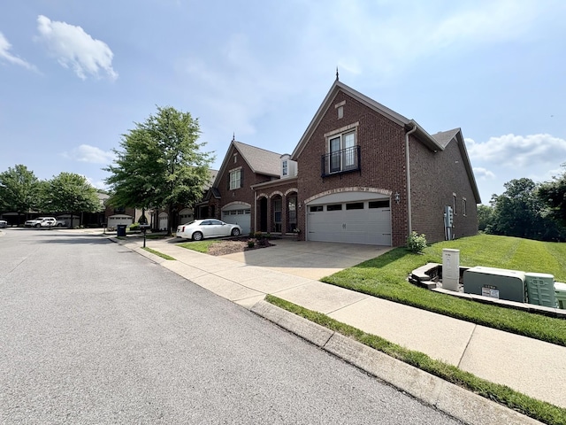 128 Village Cir, Lebanon, TN 37087 - view of front of home with brick siding, a garage, driveway, and a front lawn