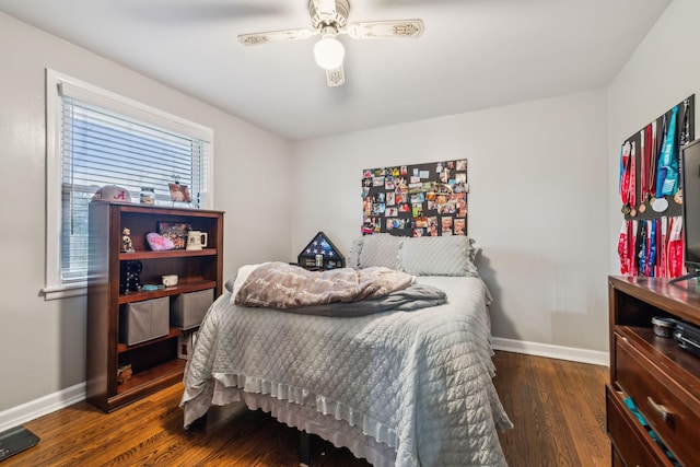 bedroom with a ceiling fan, baseboards, and dark wood-style flooring