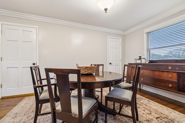 dining space featuring dark wood-style floors and ornamental molding