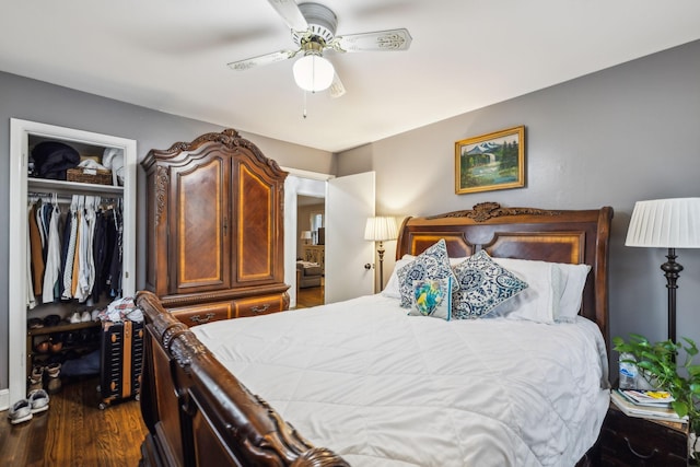 bedroom with dark wood-style floors, a ceiling fan, and a closet