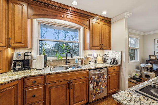 kitchen with dishwasher, light stone counters, a sink, and tasteful backsplash