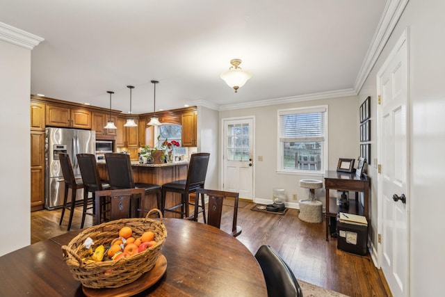 dining area featuring baseboards, ornamental molding, and dark wood-type flooring