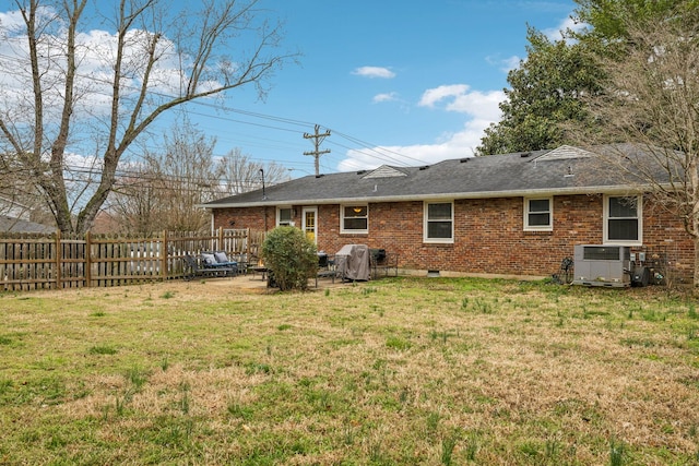 back of property featuring a patio, cooling unit, brick siding, fence, and a yard