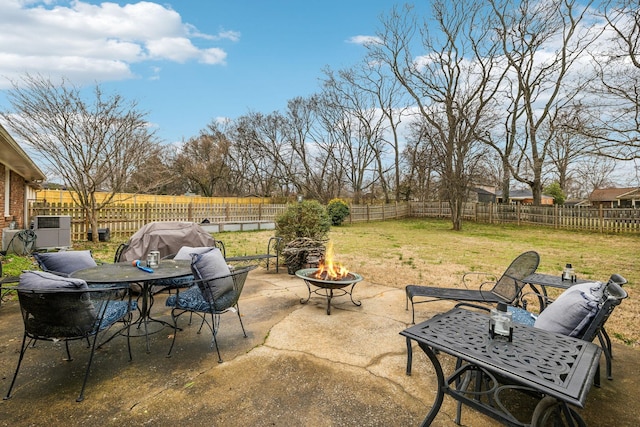 view of patio / terrace with a fenced backyard and a fire pit