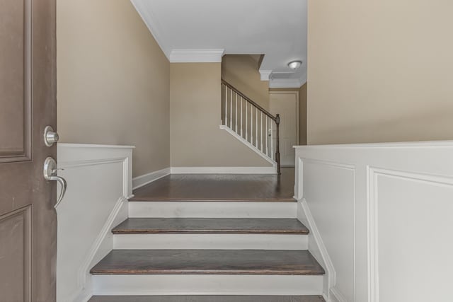 stairs featuring crown molding and baseboards