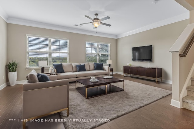 living area featuring ornamental molding, wood finished floors, visible vents, and stairs