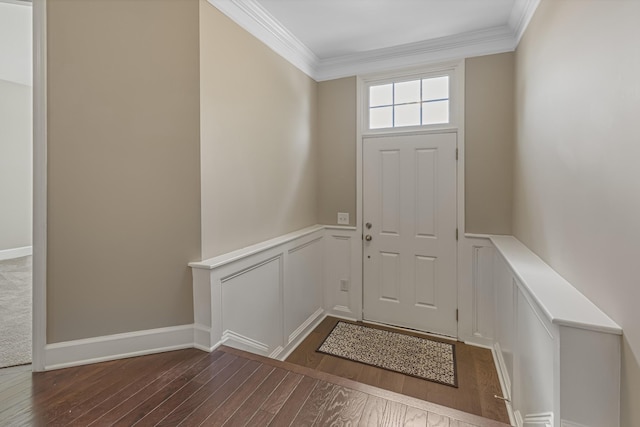 entryway with wainscoting, crown molding, a decorative wall, and wood finished floors