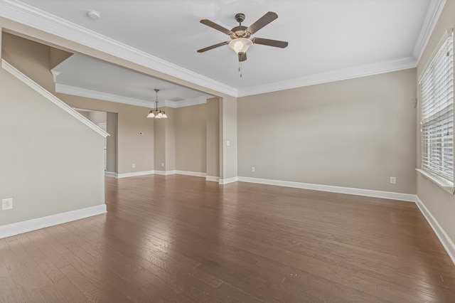 unfurnished room featuring baseboards, ceiling fan with notable chandelier, wood finished floors, and crown molding