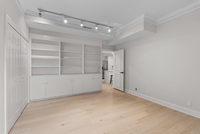 empty room with light wood-style flooring and baseboards