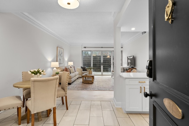 interior space featuring crown molding and light tile patterned floors