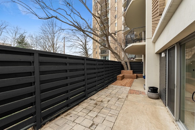 view of patio / terrace with fence and a balcony