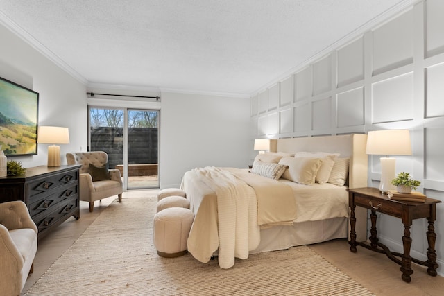 bedroom featuring access to exterior, ornamental molding, light wood finished floors, and a textured ceiling