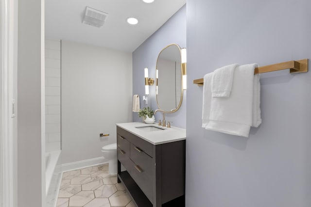 bathroom with visible vents, vanity, toilet, and baseboards