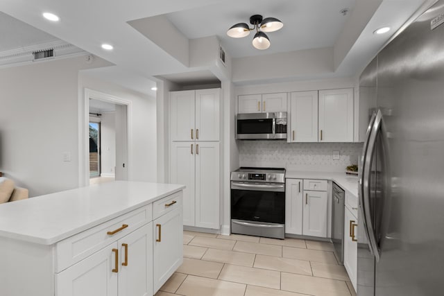 kitchen with stainless steel appliances, recessed lighting, light countertops, backsplash, and white cabinets