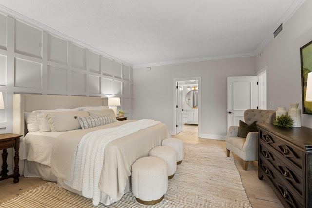 bedroom with crown molding, visible vents, light wood-style floors, connected bathroom, and baseboards