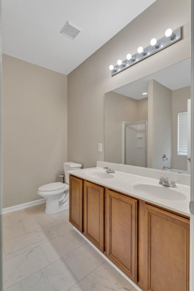 bathroom featuring double vanity, marble finish floor, a sink, and a stall shower