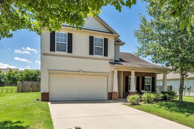 view of front facade featuring brick siding, a porch, a front yard, fence, and driveway