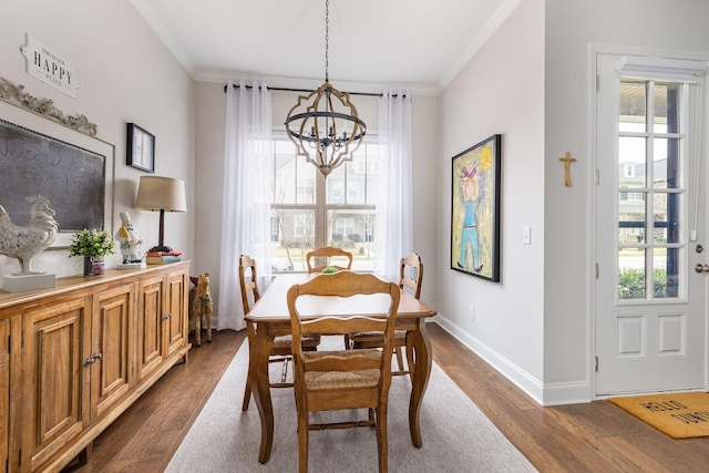 dining space with dark wood-style floors, ornamental molding, and a wealth of natural light