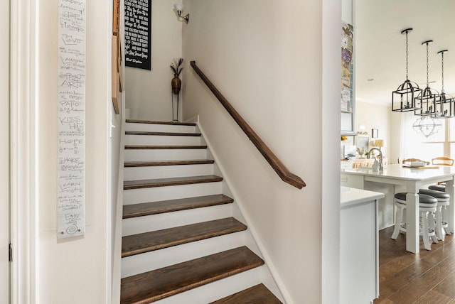 staircase featuring baseboards and wood finished floors