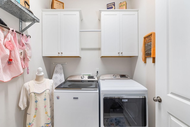 laundry area with washing machine and dryer and cabinet space