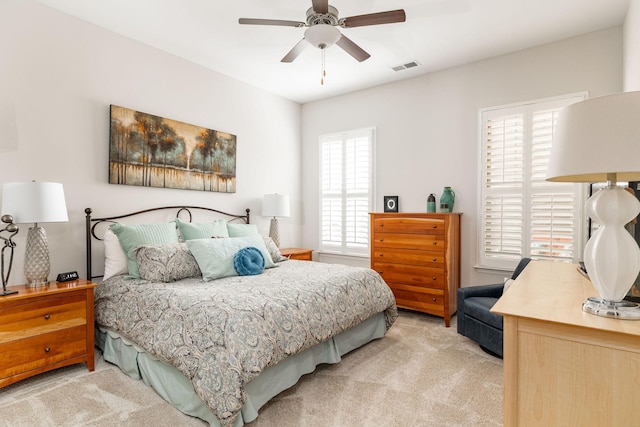 carpeted bedroom featuring visible vents and a ceiling fan